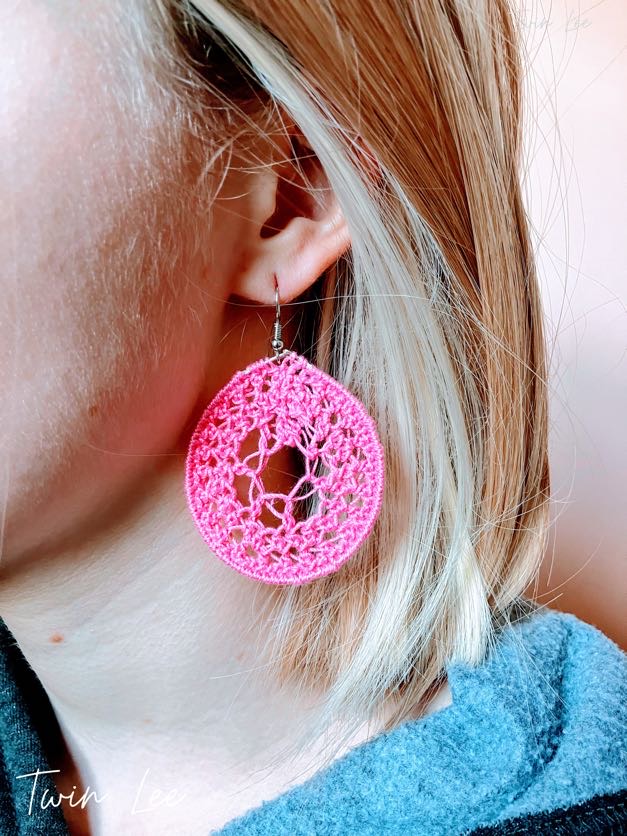 Reference image of A model wearing a crochet dark pink dream catcher