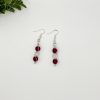 Pair of beaded red and white dangle earrings