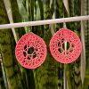 Crochet Dark Pink dream catchers hanging on a white bar in front of a green plant