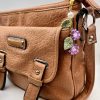 Purple flower bag charm on a brown purse