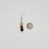 Size reference photo of wood beaded dangle earrings laying next to a quarter