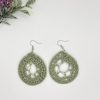 Crochet green dream catcher earrings laying next to each other on a white backdrop