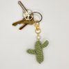Crocheted green cactus with pearl accent, on a gold snap clip, on a key ring