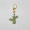 Crocheted green cactus on a gold key ring with pearl accent