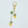 Pineapple bag charm laying flat on a white backdrop