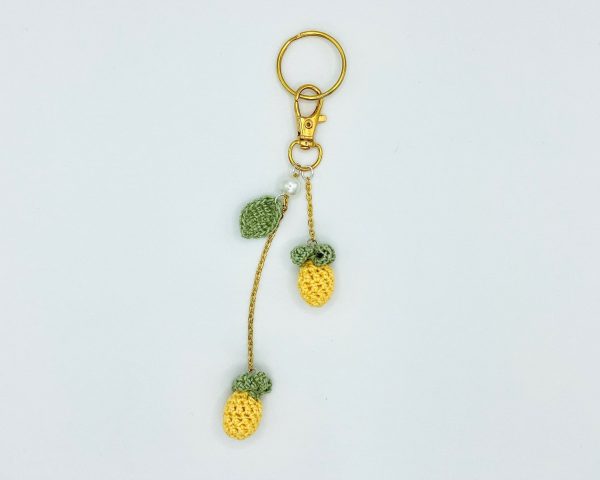 Pineapple bag charm laying flat on a white backdrop