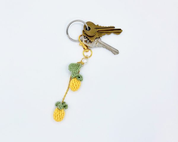 Crocheted pineapple keychain on a key ring with keys