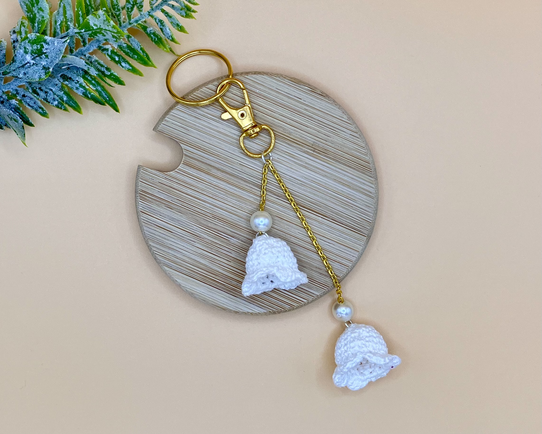 White lily of the valley bag charm with a pearl on gold chain