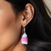Close up of woman wearing crochet candy corn dangle earrings
