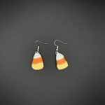 Crochet candy corn earrings on a black backdrop