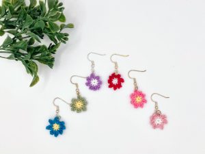 Mini flower earrings in blue, green, purple, red, dark pink, and light pink displayed against a white background