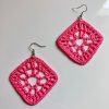 A pair of crochet pink diamond shaped earrings