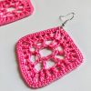 Close up of crocheted pink diamond shaped earring