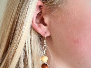 Woman wearing wood bead earrings