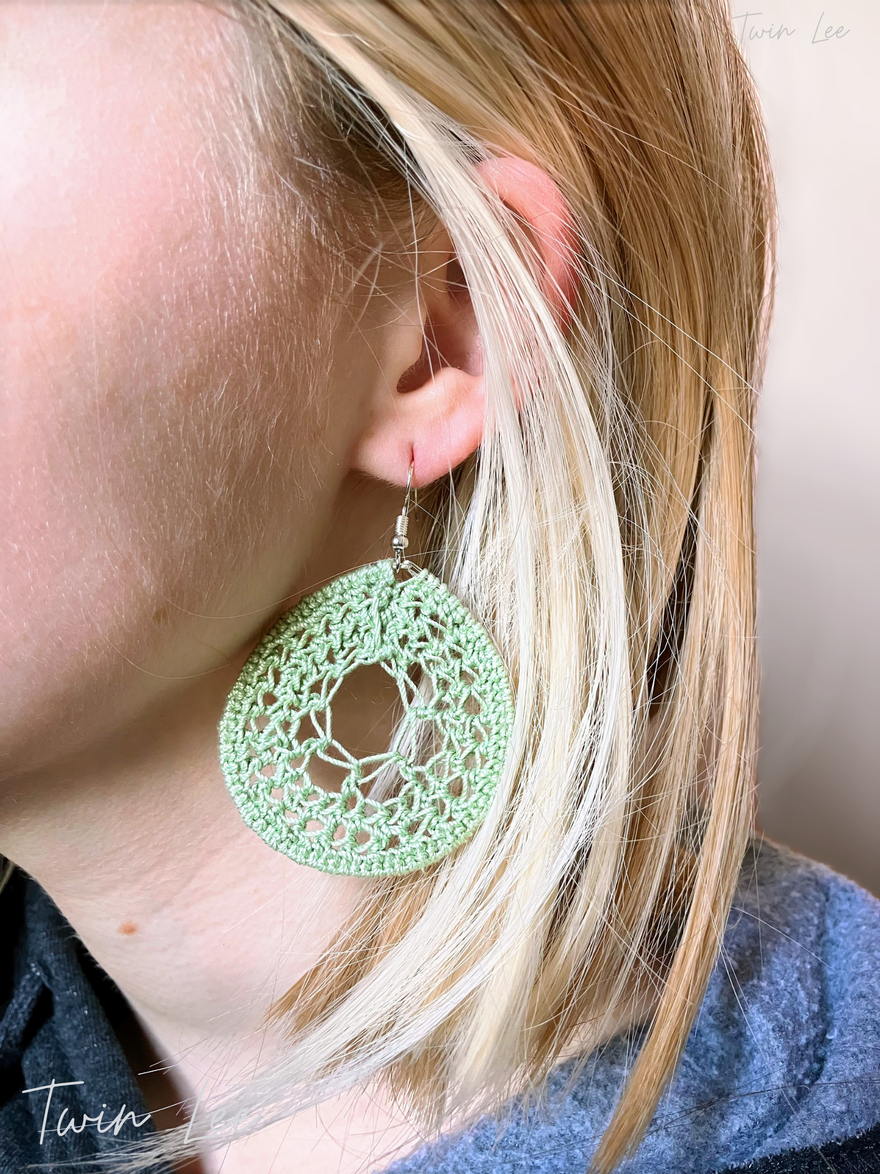 A model wearing crochet green dream catcher earrings