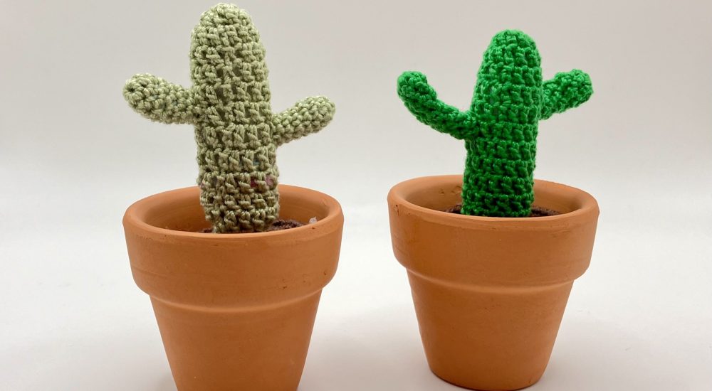 Small crochet cactus with arms in a natural clay pot, eco-friendly and handmade.