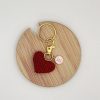 IMG_2995 Handmade crocheted red heart on a gold keyring with a personalized pastel pink and gold letter charm