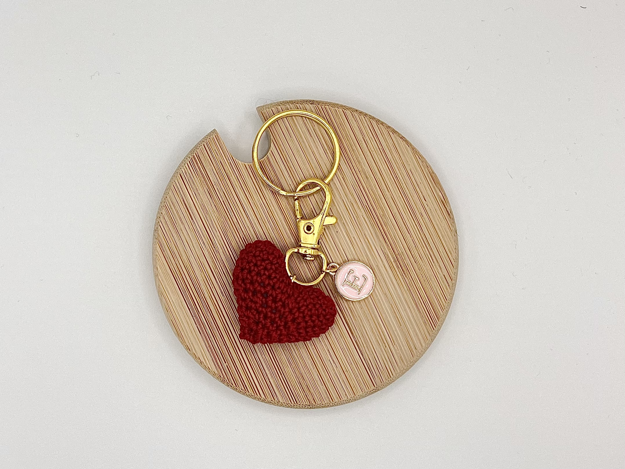 IMG_2995 Handmade crocheted red heart on a gold keyring with a personalized pastel pink and gold letter charm