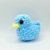 Blue crochet duck plushie turned to its side
