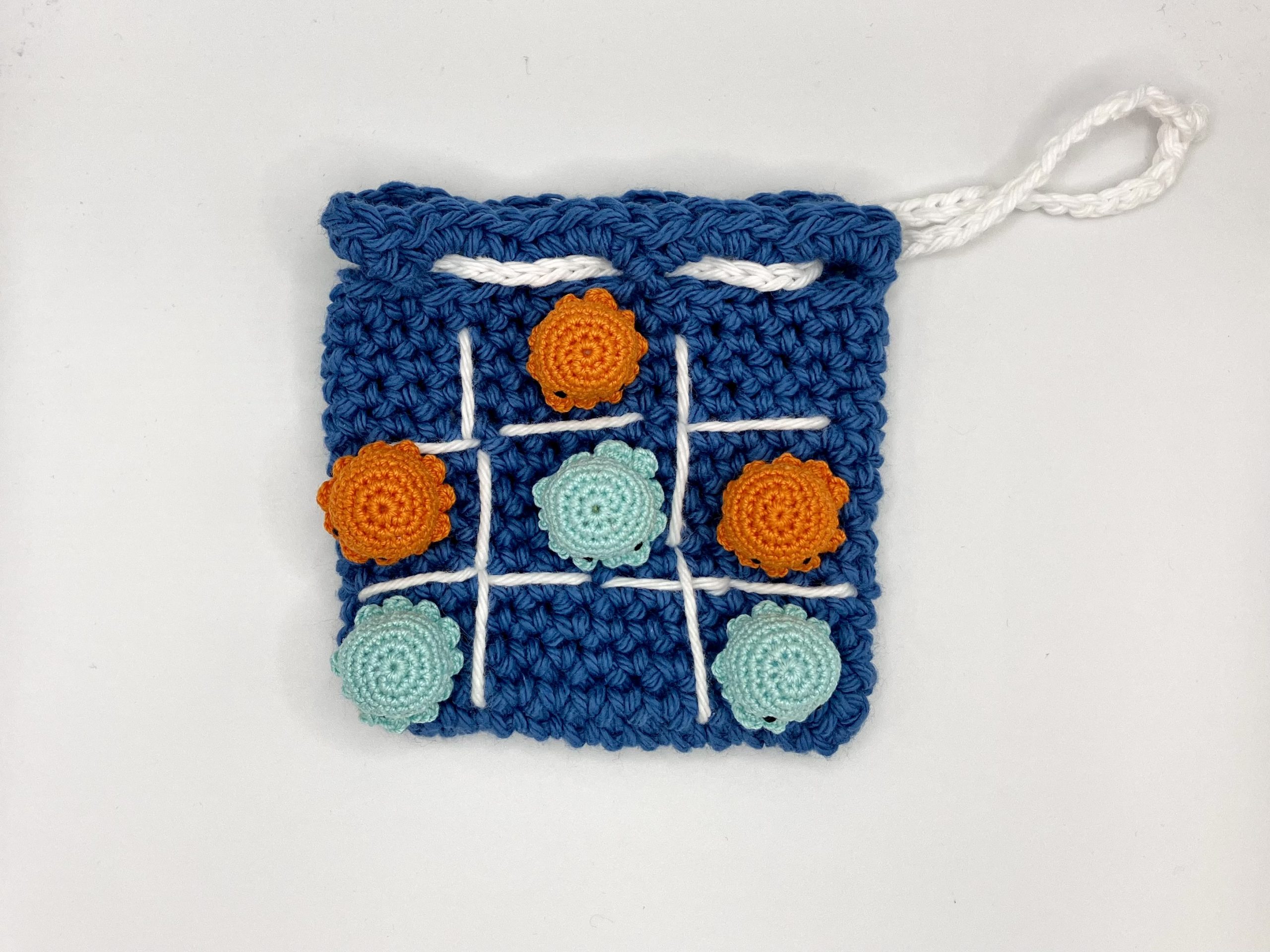 Top down view of crochet octopus tic tac toe game