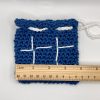 Crochet drawstring bag with ruler for size reference