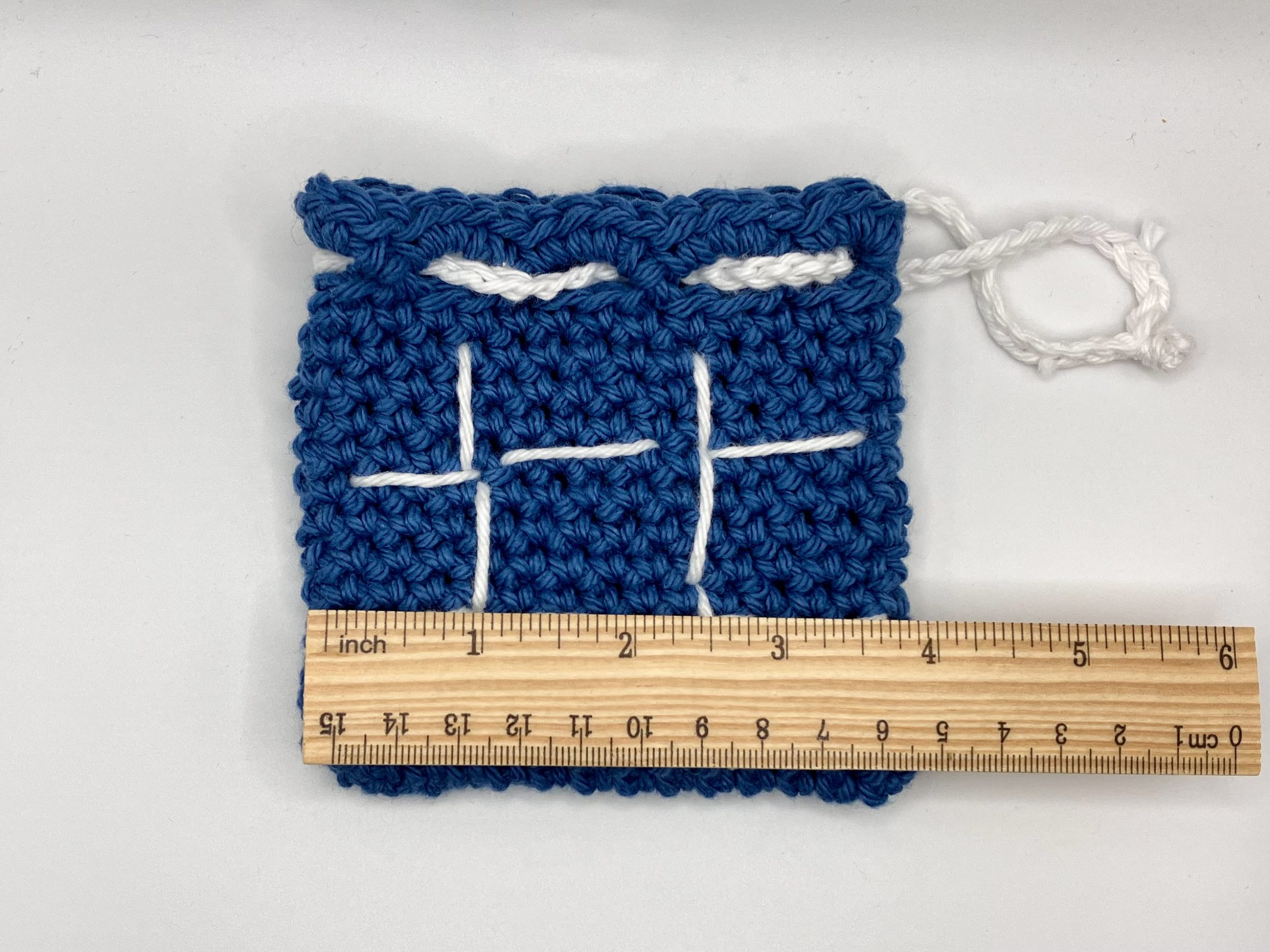 Crochet drawstring bag with ruler for size reference
